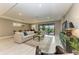 Spacious living area with large sectional sofa, access to a patio, and tile flooring at 17120 Cresswind Ter, Bradenton, FL 34211