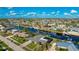 Aerial view showcasing a waterfront home with a large backyard and canal access at 181 Beeney Se Rd, Port Charlotte, FL 33952