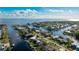Aerial view of waterfront home with private dock and boat at 181 Beeney Se Rd, Port Charlotte, FL 33952