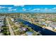 Aerial view of canal-front property with private dock and lush landscaping at 181 Beeney Se Rd, Port Charlotte, FL 33952