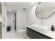 Modern bathroom with white vanity and large mirror at 181 Beeney Se Rd, Port Charlotte, FL 33952