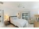 Bedroom with white bedding and pool view, mid century modern accents at 181 Beeney Se Rd, Port Charlotte, FL 33952