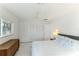 Bedroom with white bedding, built in closet, and mid century modern dresser at 181 Beeney Se Rd, Port Charlotte, FL 33952