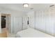 Bedroom with white bedding, built in closet and ensuite bathroom at 181 Beeney Se Rd, Port Charlotte, FL 33952