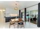 Bright dining room with mid-century modern table and chairs, and pool view at 181 Beeney Se Rd, Port Charlotte, FL 33952