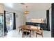 Mid-century modern dining area with wood table and chairs, and pool view at 181 Beeney Se Rd, Port Charlotte, FL 33952