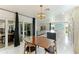 Dining area with mid-century modern table and chairs near kitchen and pool at 181 Beeney Se Rd, Port Charlotte, FL 33952