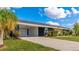 Ranch style home with carport and well-maintained lawn at 181 Beeney Se Rd, Port Charlotte, FL 33952