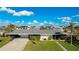 Mid-century modern home with carport and landscaped yard at 181 Beeney Se Rd, Port Charlotte, FL 33952