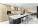 Modern kitchen with light wood cabinets, stainless steel appliances, and large island at 181 Beeney Se Rd, Port Charlotte, FL 33952