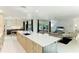 Modern kitchen with large island, stainless steel appliances, and white quartz countertops at 181 Beeney Se Rd, Port Charlotte, FL 33952