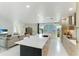Open concept kitchen and living area with large island and stone accent wall at 181 Beeney Se Rd, Port Charlotte, FL 33952