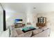 Bright living room featuring a sectional sofa and stone accent wall at 181 Beeney Se Rd, Port Charlotte, FL 33952
