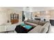 Living room with sectional sofa, stone accent wall, and mid-century modern decor at 181 Beeney Se Rd, Port Charlotte, FL 33952