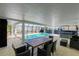 Covered patio with pool, hot tub, and outdoor dining area at 181 Beeney Se Rd, Port Charlotte, FL 33952