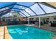 Relaxing screened pool with jacuzzi and lounge chairs at 181 Beeney Se Rd, Port Charlotte, FL 33952
