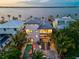 Aerial view of waterfront home with pool, spa, and outdoor seating at 1914 Riverside E Dr, Bradenton, FL 34208