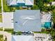 Aerial view showcasing a home with pool and lush landscaping at 1914 Riverside E Dr, Bradenton, FL 34208