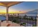 Balcony overlooking the water with sunset views and modern railing at 1914 Riverside E Dr, Bradenton, FL 34208