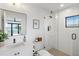 Modern bathroom with white tile and glass shower at 1914 Riverside E Dr, Bradenton, FL 34208