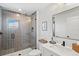 Modern bathroom with gray tile, a glass shower, and white vanity at 1914 Riverside E Dr, Bradenton, FL 34208