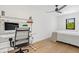 Bedroom with built-in workspace and hardwood floors at 1914 Riverside E Dr, Bradenton, FL 34208