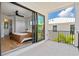 Bedroom with private balcony and access to bathroom at 1914 Riverside E Dr, Bradenton, FL 34208