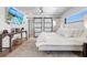 Main bedroom with large windows, a king-size bed, and a barn door at 1914 Riverside E Dr, Bradenton, FL 34208