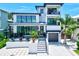Modern two-story home with a gray metal roof and inviting porch at 1914 Riverside E Dr, Bradenton, FL 34208