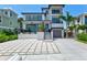 Modern two-story home with a spacious driveway and landscape at 1914 Riverside E Dr, Bradenton, FL 34208