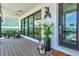 Inviting front porch with deck, potted plants, and seating at 1914 Riverside E Dr, Bradenton, FL 34208