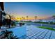 Landscaped front yard with paver driveway and sunset view at 1914 Riverside E Dr, Bradenton, FL 34208