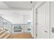 Bright hallway with wood floors and modern metal railing at 1914 Riverside E Dr, Bradenton, FL 34208