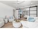 Open living area with white couches and a view into the bedroom at 1914 Riverside E Dr, Bradenton, FL 34208