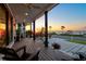 Relaxing waterfront porch with sunset views, comfy chairs, and modern design at 1914 Riverside E Dr, Bradenton, FL 34208