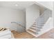 Modern staircase with light wood treads and metal railing at 1914 Riverside E Dr, Bradenton, FL 34208
