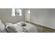 Bright bedroom with wood-look floors and access to a private bathroom at 2726 Jerry Ave, Punta Gorda, FL 33950