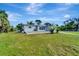 Newly renovated home with gray siding, spacious lawn, and a deck at 2726 Jerry Ave, Punta Gorda, FL 33950