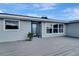 Gray house with a blue door and a large deck at 2726 Jerry Ave, Punta Gorda, FL 33950