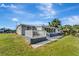 Back of the house with a deck and lush green lawn at 2726 Jerry Ave, Punta Gorda, FL 33950