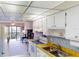 Bright kitchen features wood countertops, white cabinets, and a view to the dining area at 305 30Th W Ave # A308, Bradenton, FL 34205