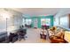 Open living area with seating, a workspace, and dining space at 305 30Th W Ave # A308, Bradenton, FL 34205