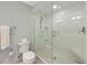 Clean bathroom with a toilet, shower, and white tile at 315 Hammock Cir, Anna Maria, FL 34216