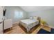 Cozy bedroom with a queen-size bed and light wood floors at 315 Hammock Cir, Anna Maria, FL 34216
