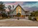 A charming two-story home with a large window and elevated deck at 315 Hammock Cir, Anna Maria, FL 34216