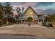 Elevated A-frame home with large windows and balcony at 315 Hammock Cir, Anna Maria, FL 34216