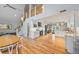 Open concept kitchen with white cabinets, stainless steel appliances, and hardwood floors at 315 Hammock Cir, Anna Maria, FL 34216