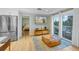 Living room with hardwood floors, a large TV, and access to a bedroom and balcony at 315 Hammock Cir, Anna Maria, FL 34216