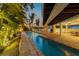 Long, inviting pool with patio and outdoor dining area at 315 Hammock Cir, Anna Maria, FL 34216