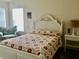 Bright bedroom with a white bed frame and floral bedding at 322 Blackburn Blvd, North Port, FL 34287